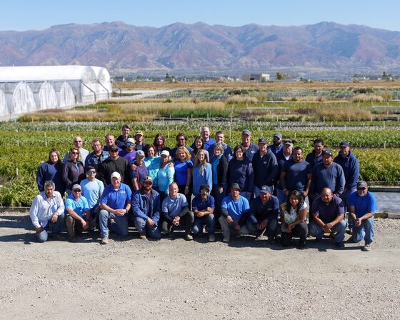 The Perennial Favorites crew gathered together in front of the growing fields