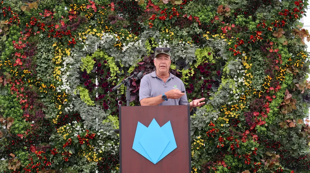 John Bergman speaking at the podium