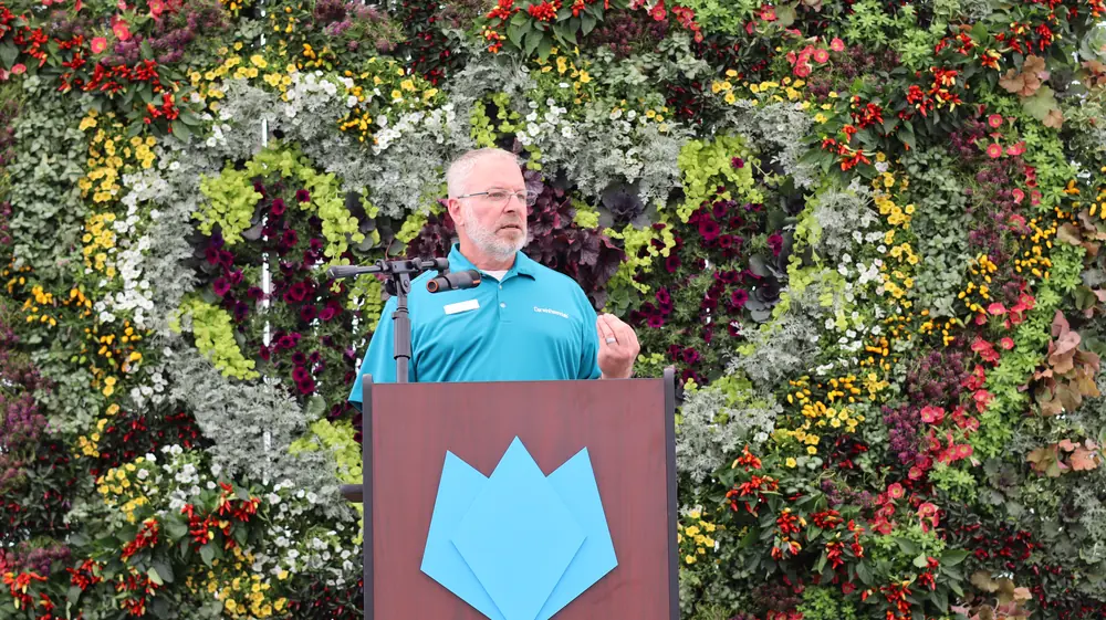 Chris Fifo speaking at the podium
