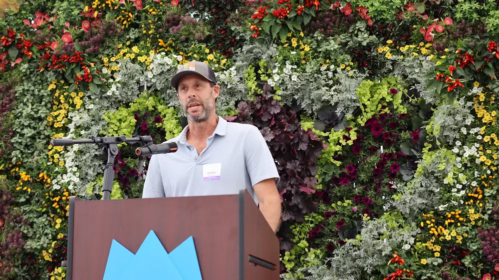 Curtis Manning speaking at the podium