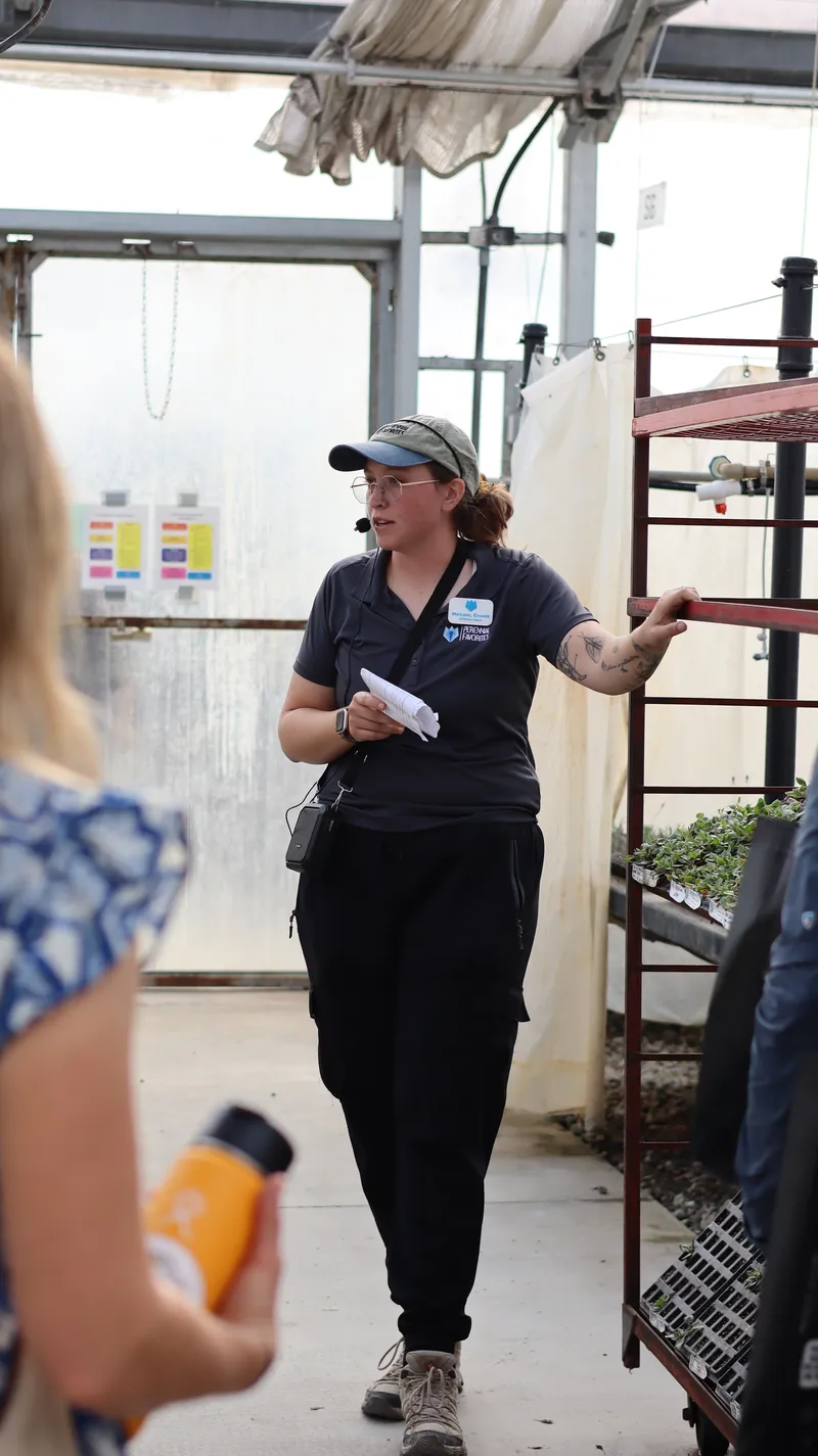 Macahl leading a tour group through the Propagation House, wearing a headset mic