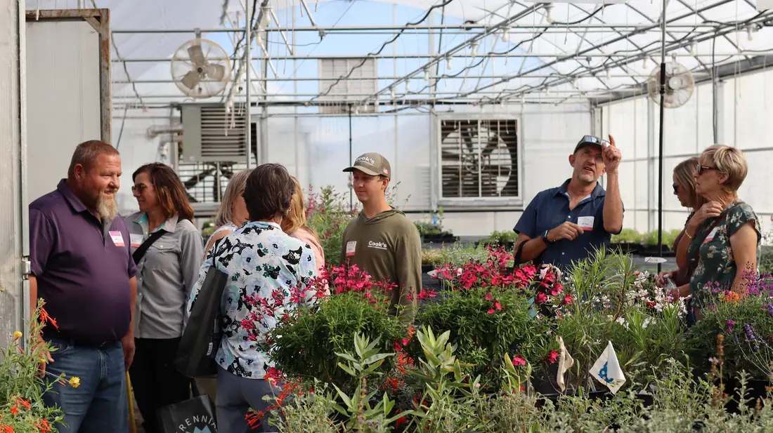 Guests looking at plants in the propagation greenhouse