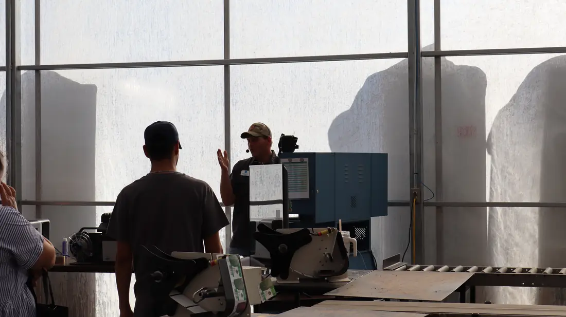 Crew member at the label printer on the processing line