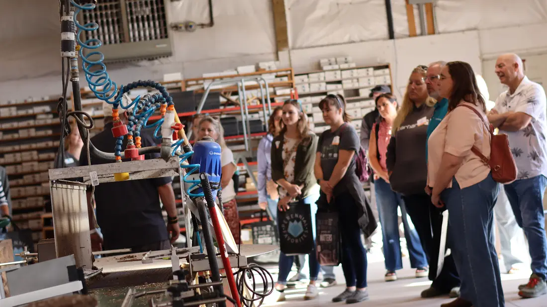 Guests watching production equipment