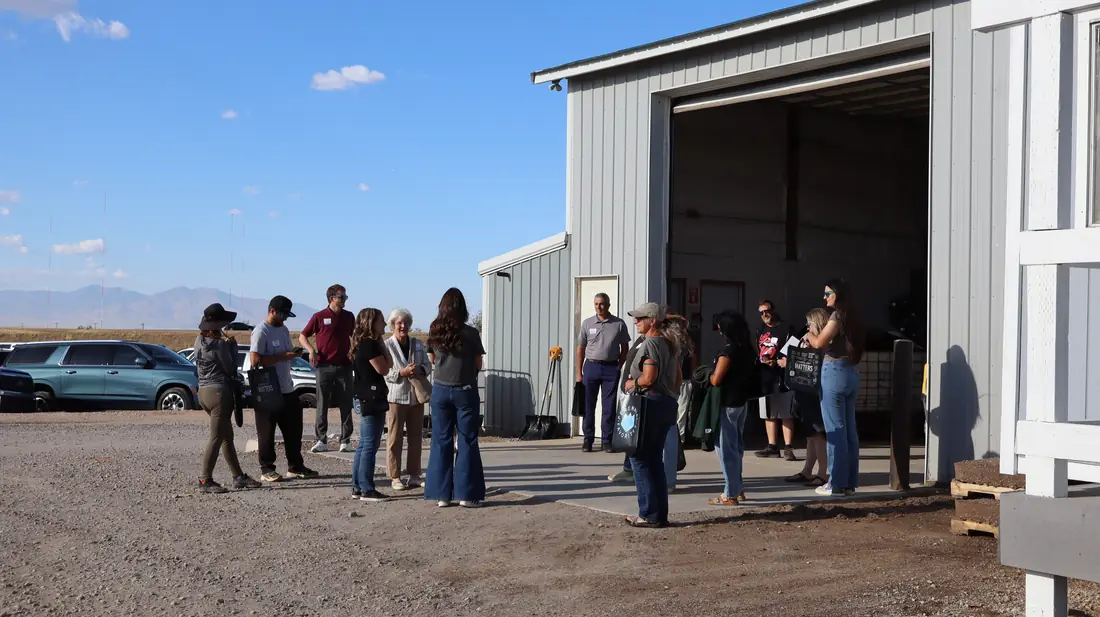 Tour group outside the production building