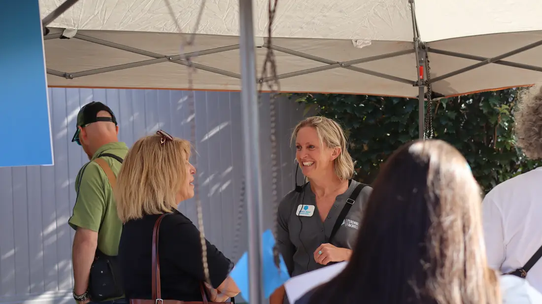 Trial Garden host talking with guests under the tent